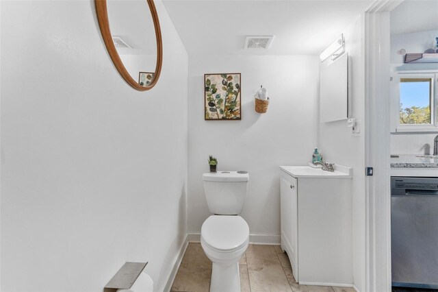 bathroom with tile patterned flooring, vanity, and toilet