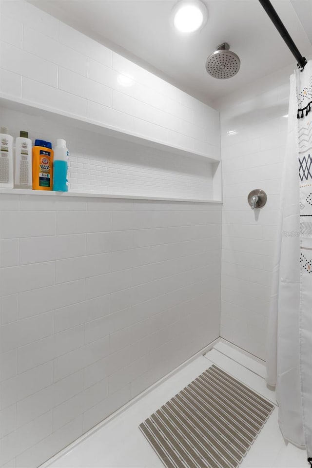 bathroom with tile patterned flooring and a shower with shower curtain