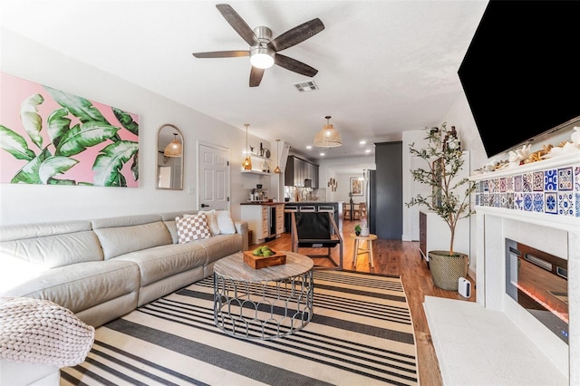 727 53rd Ter N, Saint Petersburg, FL 33703 - living room with light wood-type flooring, visible vents, recessed lighting, ceiling fan, and a tile fireplace