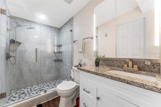 727 53rd Ter N, Saint Petersburg, FL 33703 - full bath featuring vanity, wood finished floors, visible vents, a shower stall, and toilet
