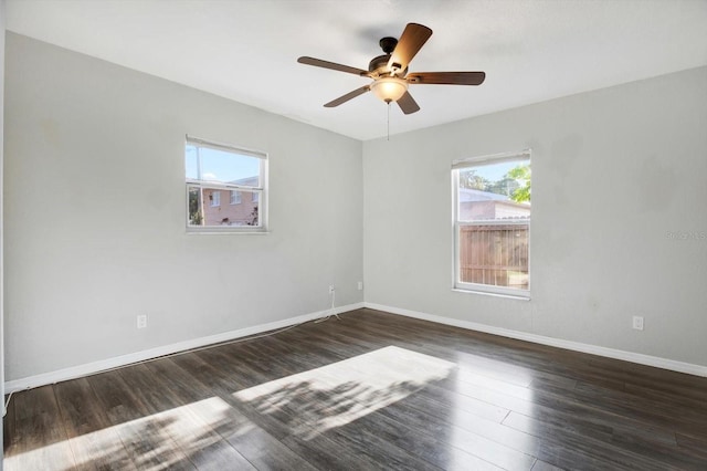 spare room featuring ceiling fan and dark wood-type flooring