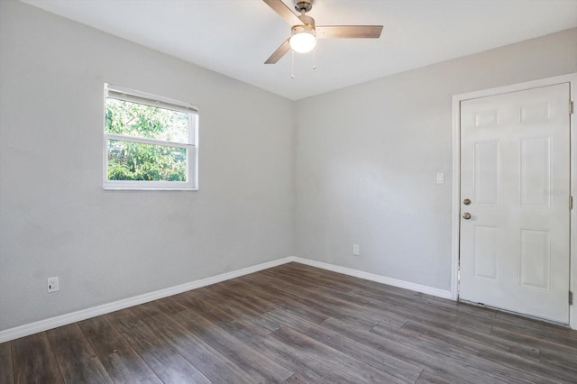 spare room with ceiling fan and dark hardwood / wood-style flooring