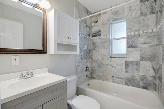 full bathroom featuring vanity, toilet, and tiled shower / bath