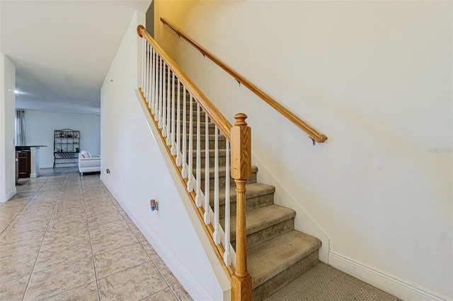 staircase featuring tile patterned floors