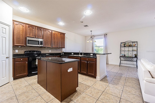 kitchen featuring pendant lighting, a center island, a textured ceiling, black / electric stove, and kitchen peninsula