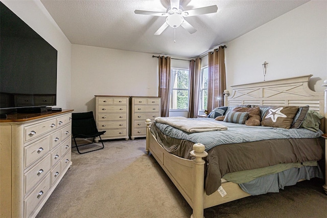 carpeted bedroom with a textured ceiling and ceiling fan