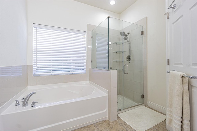 bathroom featuring tile patterned flooring and independent shower and bath