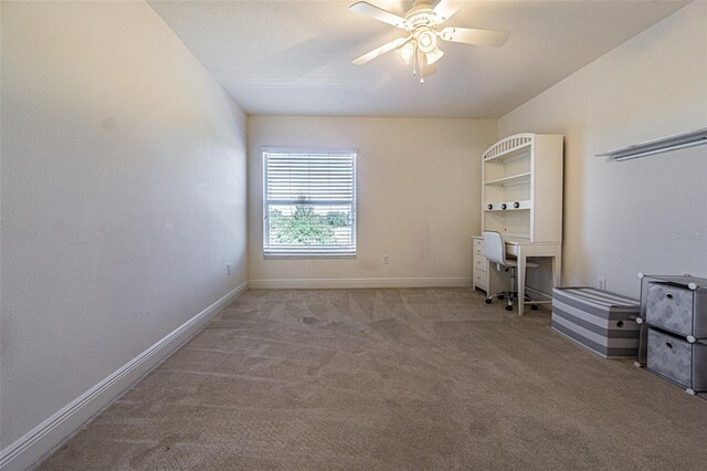 unfurnished bedroom with ceiling fan and light colored carpet