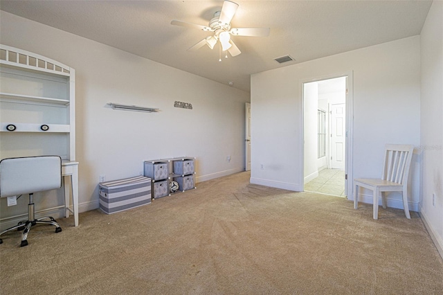 office space with light carpet and ceiling fan