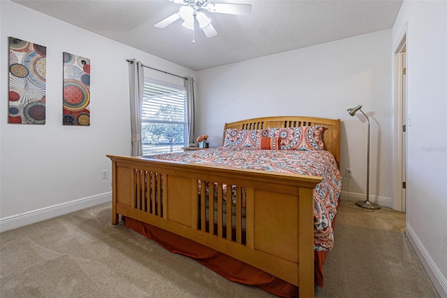 bedroom featuring a textured ceiling, ceiling fan, and light carpet