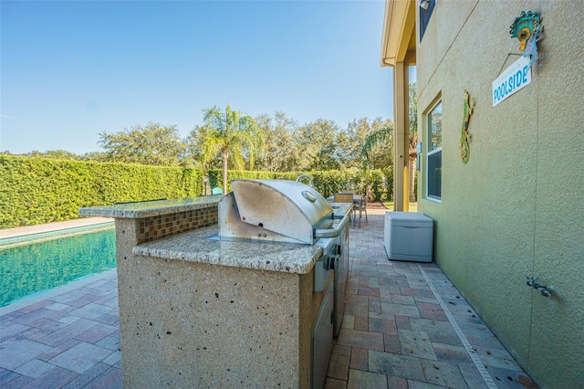 view of patio featuring exterior kitchen and grilling area