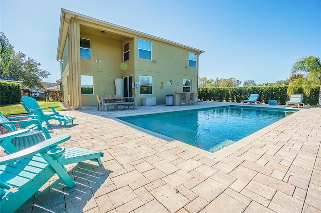 view of pool with a patio and exterior kitchen