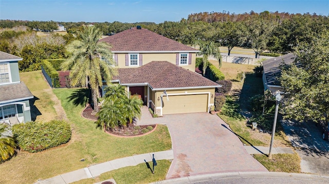 view of front of property with a front yard and a garage