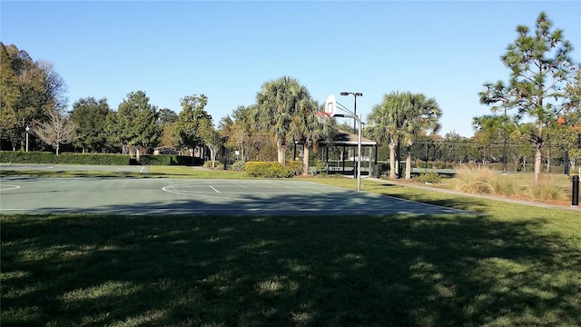 view of basketball court featuring a lawn