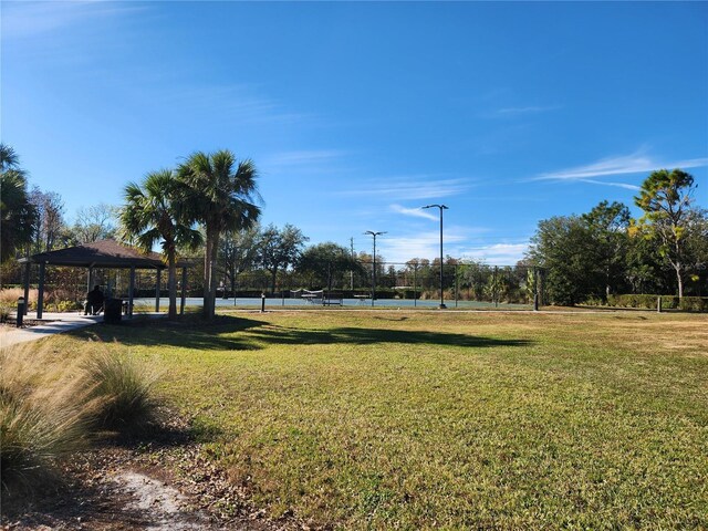 surrounding community with a gazebo, a yard, and tennis court