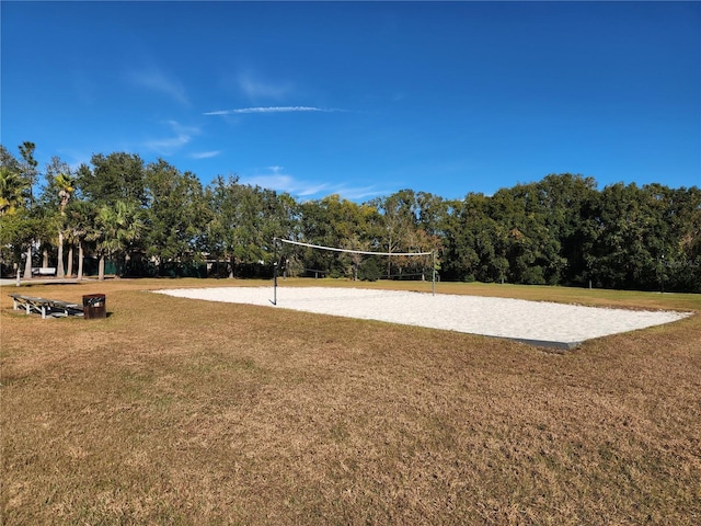 view of home's community featuring volleyball court and a yard