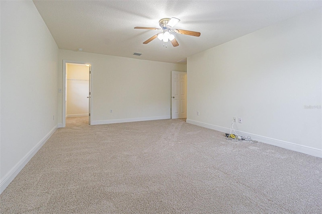 5709 White Trillium Loop, Land O Lakes, FL 34639 - spare room with a ceiling fan, light colored carpet, and baseboards