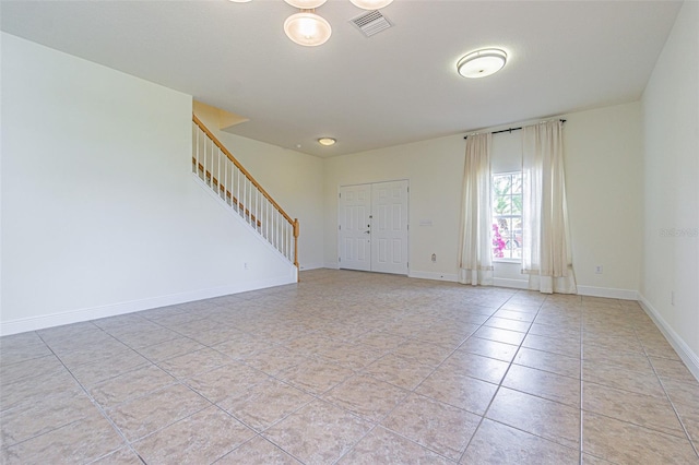 5709 White Trillium Loop, Land O Lakes, FL 34639 - unfurnished room featuring stairs, baseboards, and light tile patterned flooring