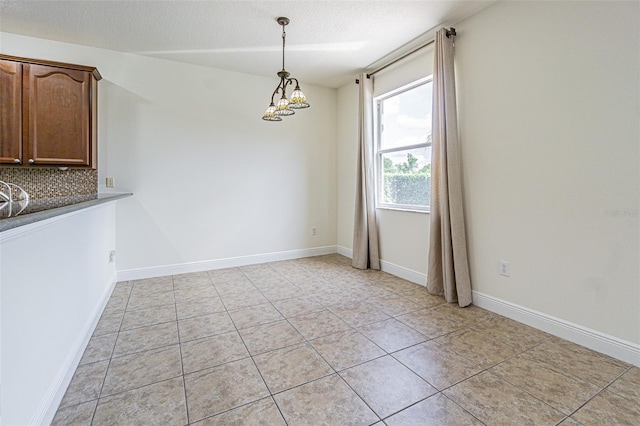 5709 White Trillium Loop, Land O Lakes, FL 34639 - unfurnished dining area featuring light tile patterned flooring, a chandelier, and a textured ceiling