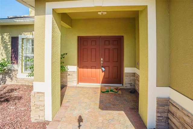 5709 White Trillium Loop, Land O Lakes, FL 34639 - entrance to property featuring stucco siding and stone siding