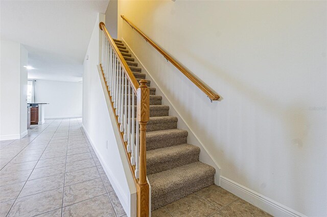 5709 White Trillium Loop, Land O Lakes, FL 34639 - staircase with tile patterned floors and baseboards