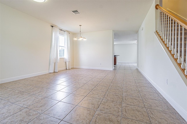 5709 White Trillium Loop, Land O Lakes, FL 34639 - empty room featuring tile patterned flooring, stairway, and baseboards