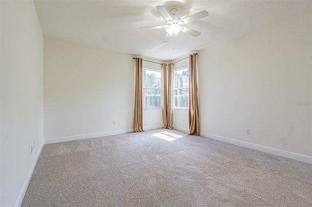 5709 White Trillium Loop, Land O Lakes, FL 34639 - spare room with a ceiling fan, light colored carpet, and baseboards