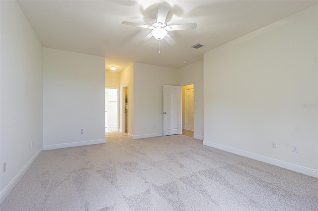5709 White Trillium Loop, Land O Lakes, FL 34639 - unfurnished bedroom with light colored carpet, baseboards, and a ceiling fan
