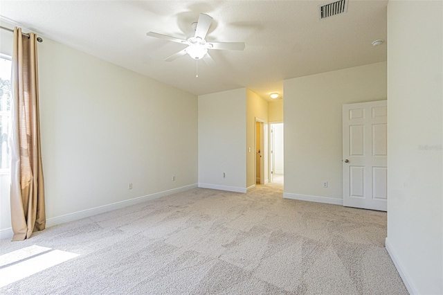 5709 White Trillium Loop, Land O Lakes, FL 34639 - empty room featuring light carpet, ceiling fan, and baseboards