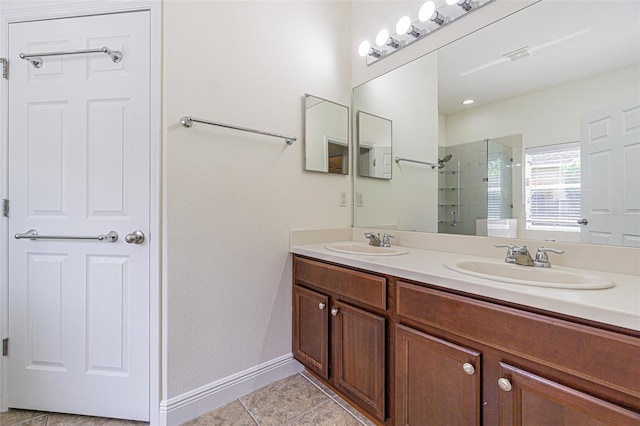 5709 White Trillium Loop, Land O Lakes, FL 34639 - full bathroom with a stall shower, tile patterned flooring, double vanity, and baseboards