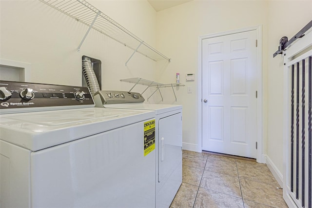 5709 White Trillium Loop, Land O Lakes, FL 34639 - laundry area featuring washing machine and clothes dryer, baseboards, and light tile patterned flooring