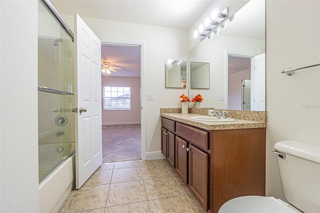 5709 White Trillium Loop, Land O Lakes, FL 34639 - bathroom with toilet, vanity, tile patterned floors, and enclosed tub / shower combo