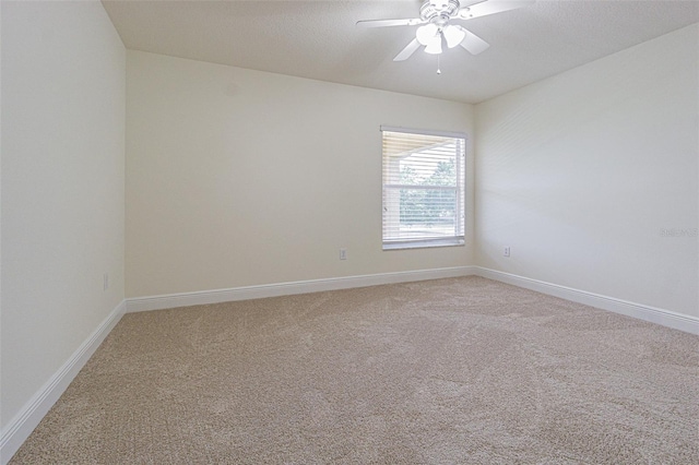 5709 White Trillium Loop, Land O Lakes, FL 34639 - spare room featuring light carpet, ceiling fan, and baseboards
