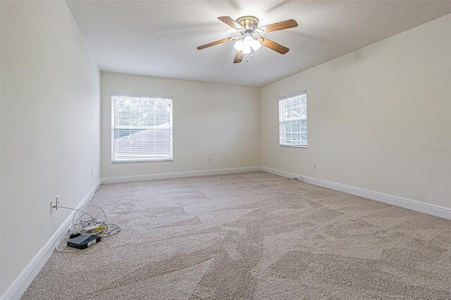 5709 White Trillium Loop, Land O Lakes, FL 34639 - empty room with light colored carpet, ceiling fan, baseboards, and a textured ceiling