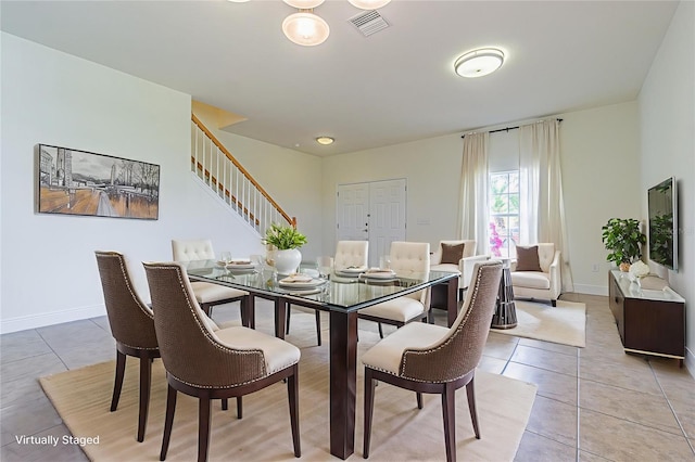 5709 White Trillium Loop, Land O Lakes, FL 34639 - dining room with light tile patterned flooring and stairway