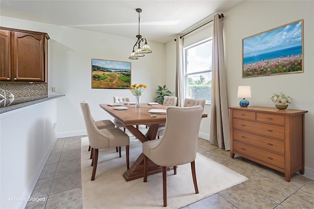 5709 White Trillium Loop, Land O Lakes, FL 34639 - dining area with light tile patterned floors and a chandelier