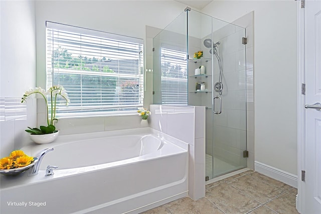 5709 White Trillium Loop, Land O Lakes, FL 34639 - bathroom with a bath, a stall shower, and tile patterned flooring