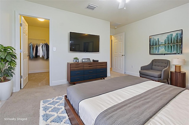 5709 White Trillium Loop, Land O Lakes, FL 34639 - bedroom featuring a spacious closet, light carpet, a closet, and a ceiling fan