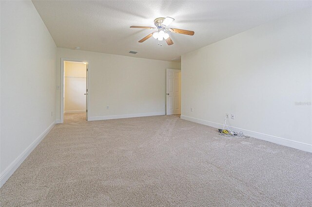 5709 White Trillium Loop, Land O Lakes, FL 34639 - spare room with ceiling fan, light carpet, and baseboards