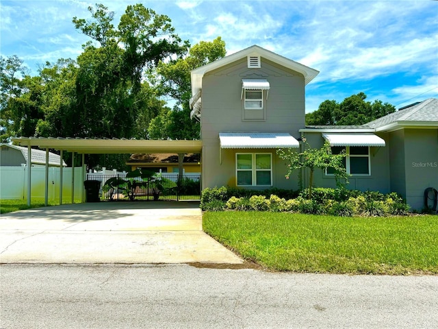 1003 Beverly Ave, Largo, FL 33770 - view of front of property with driveway, an attached carport, and stucco siding
