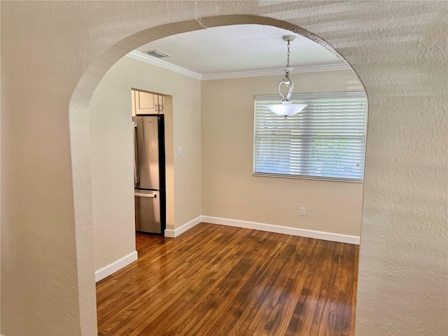 1003 Beverly Ave, Largo, FL 33770 - empty room with arched walkways, ornamental molding, wood-type flooring, baseboards, and a textured wall