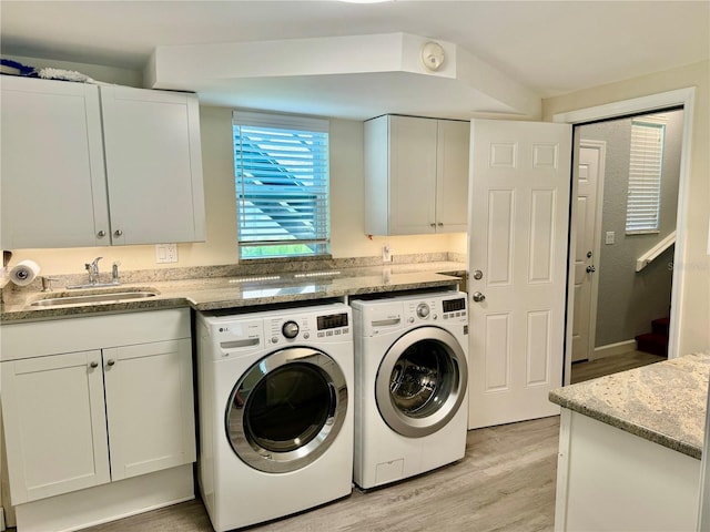 1003 Beverly Ave, Largo, FL 33770 - laundry room with independent washer and dryer, cabinet space, and light wood finished floors