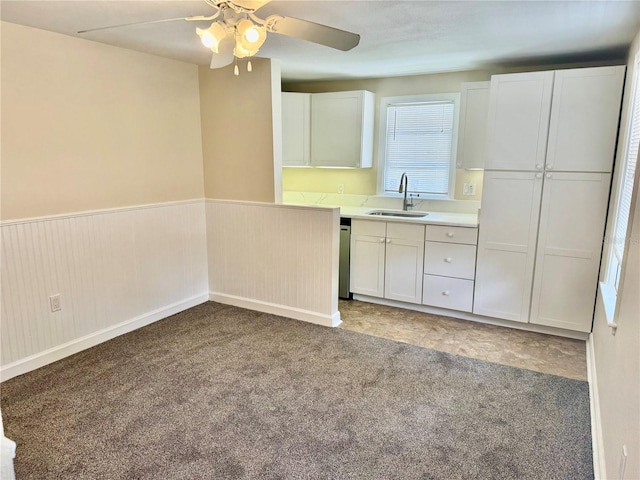 1003 Beverly Ave, Largo, FL 33770 - kitchen with a sink, a ceiling fan, light colored carpet, white cabinets, and light countertops