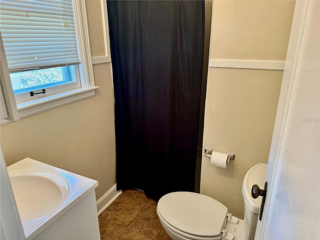 1003 Beverly Ave, Largo, FL 33770 - bathroom with toilet, a shower with curtain, a sink, and baseboards
