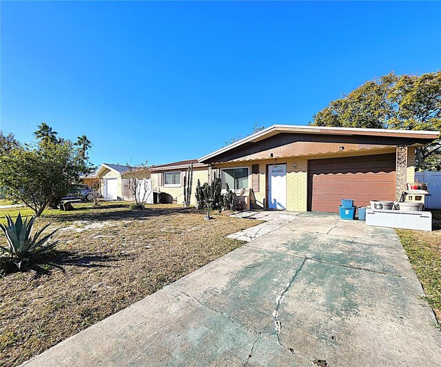 7521 Coventry Dr, Port Richey, FL 34668 - view of front of home featuring brick siding, driveway, and an attached garage