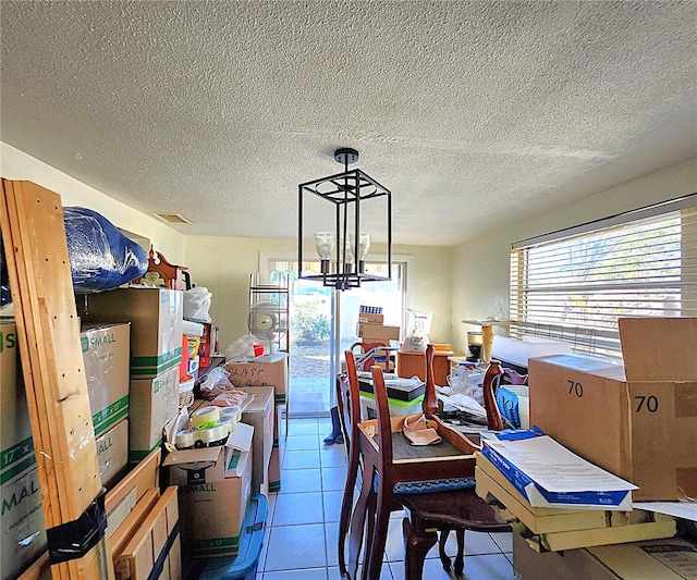 dining room with light tile patterned floors and an inviting chandelier