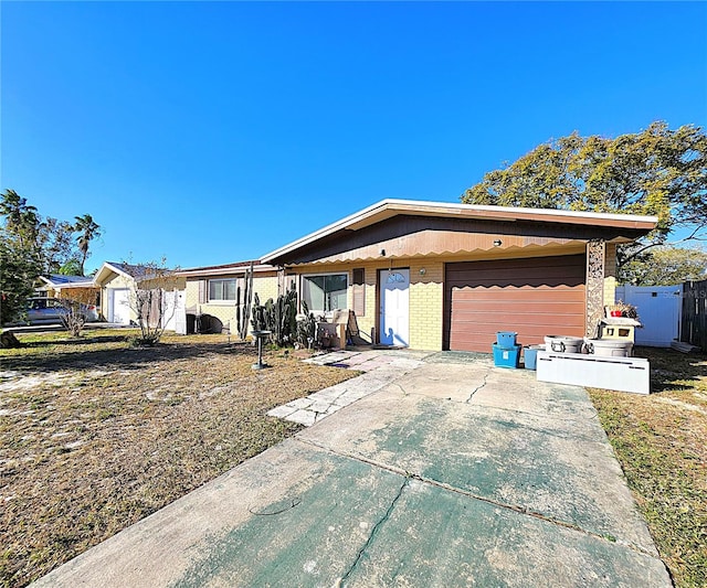 view of front of property with a garage and a front lawn