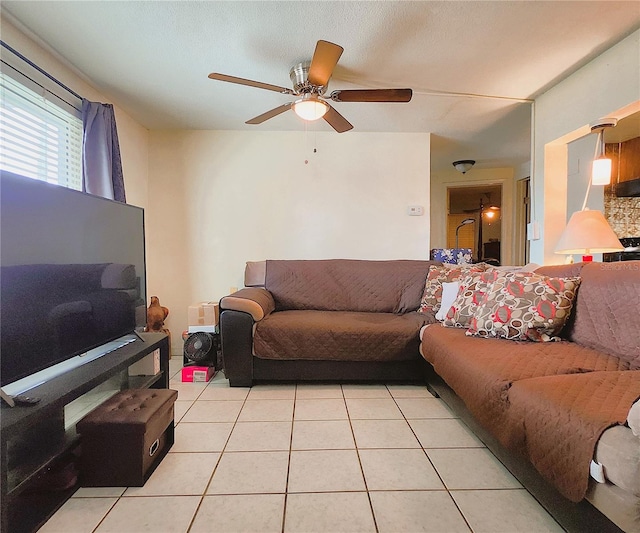 living room with ceiling fan and light tile patterned floors