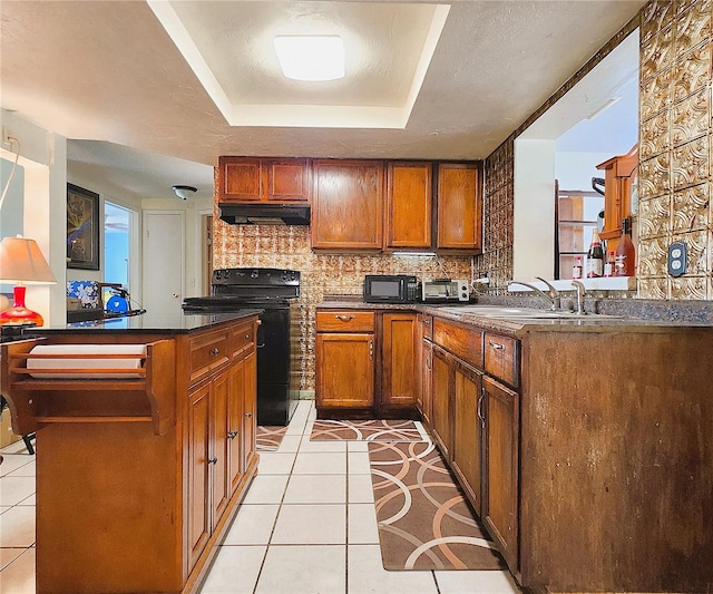 kitchen featuring a raised ceiling, sink, electric range, decorative backsplash, and light tile patterned floors