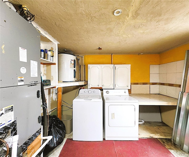 laundry room featuring separate washer and dryer, water heater, heating unit, and cabinets